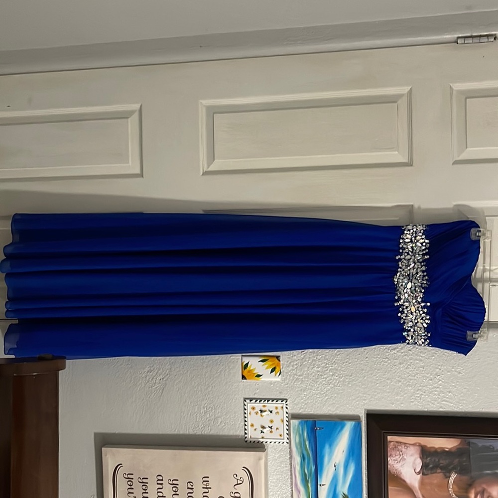 Blue long strapless dress, with crystal in the front. Only worn once.